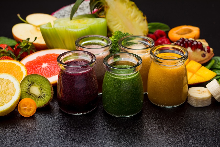 Jars containing different flavors of fruit juices for nutritious drink recipes